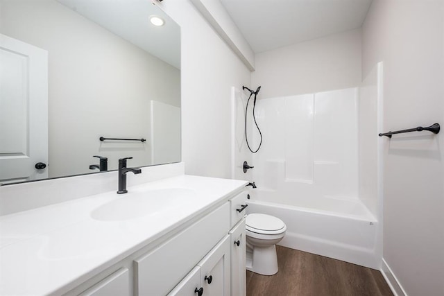 full bathroom featuring vanity, toilet, hardwood / wood-style floors, and shower / bathing tub combination