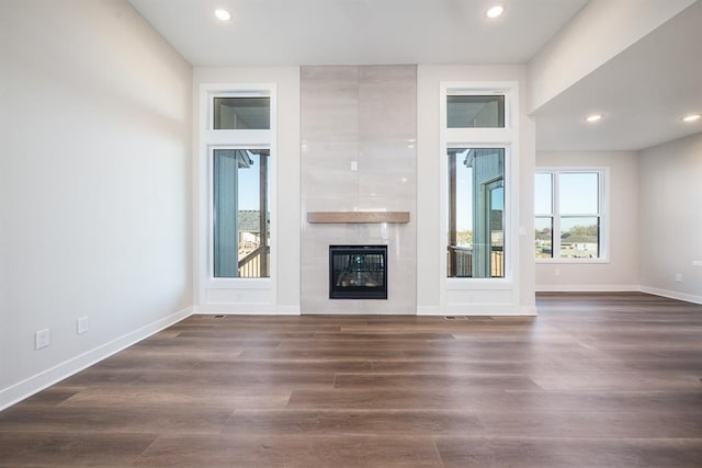 unfurnished living room with a fireplace and dark hardwood / wood-style flooring