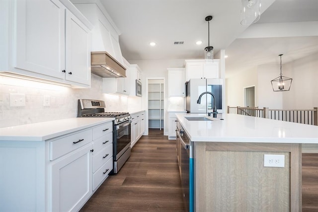 kitchen with a spacious island, white cabinetry, appliances with stainless steel finishes, and pendant lighting