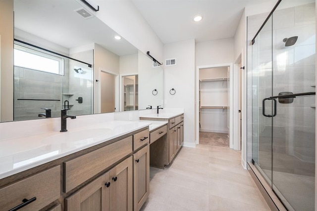 bathroom featuring vanity, tile patterned flooring, and a shower with door