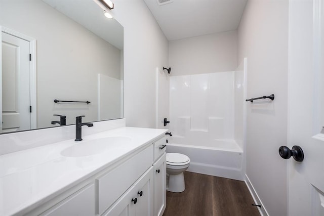 full bathroom with wood-type flooring, shower / washtub combination, vanity, and toilet