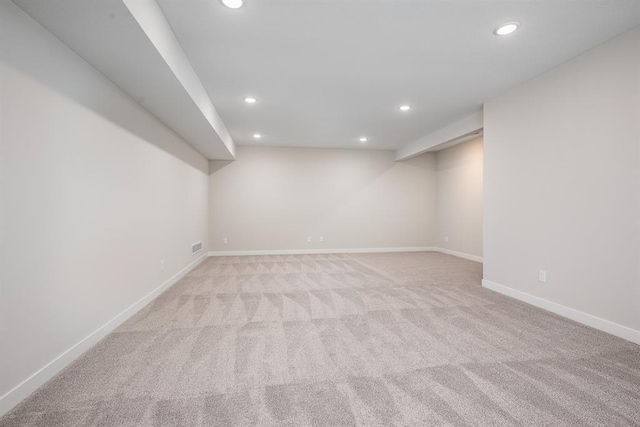 basement featuring light colored carpet