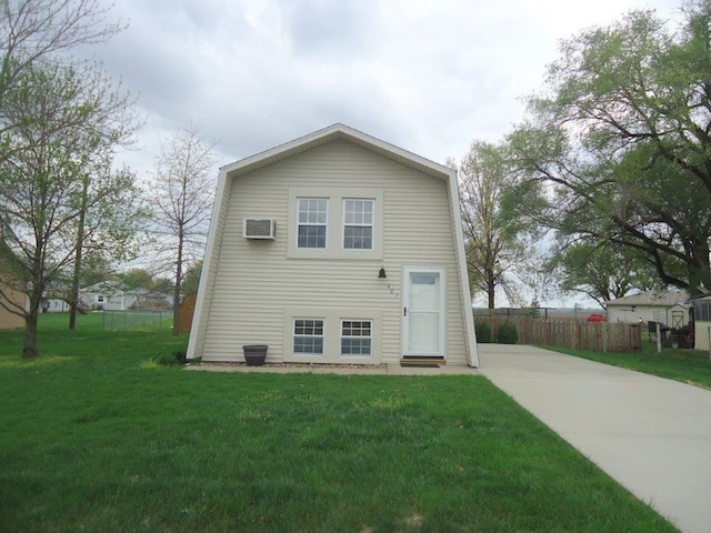 exterior space featuring a wall unit AC and a front yard