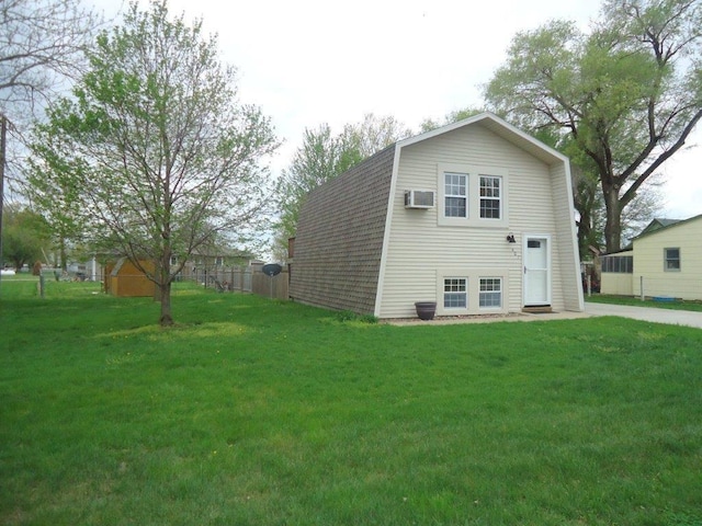 view of property exterior with a lawn and a wall mounted AC