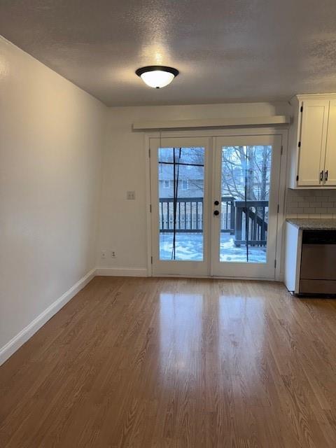 interior space with light hardwood / wood-style floors and a textured ceiling