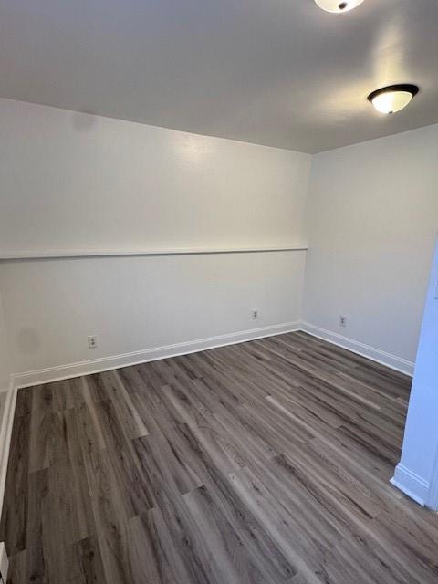 unfurnished room featuring dark wood-type flooring