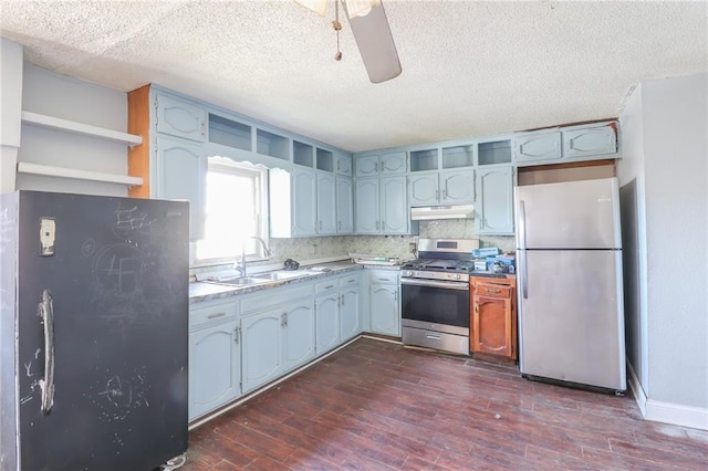 kitchen featuring dark wood-type flooring, sink, ceiling fan, stainless steel appliances, and decorative backsplash