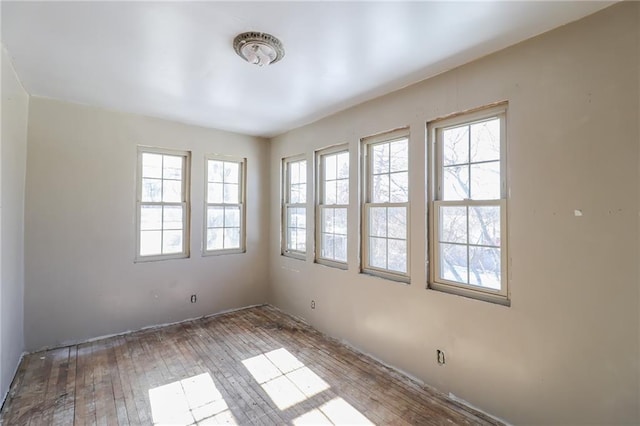 spare room with light hardwood / wood-style flooring