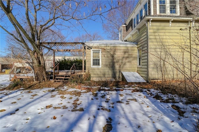 snow covered property with a wooden deck