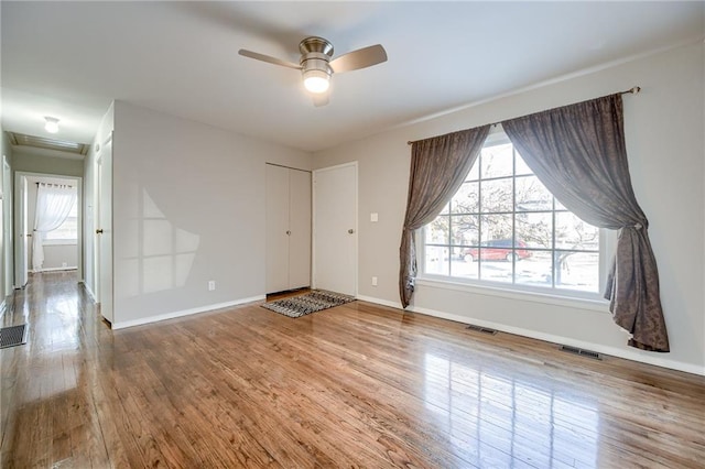 spare room with hardwood / wood-style flooring and ceiling fan