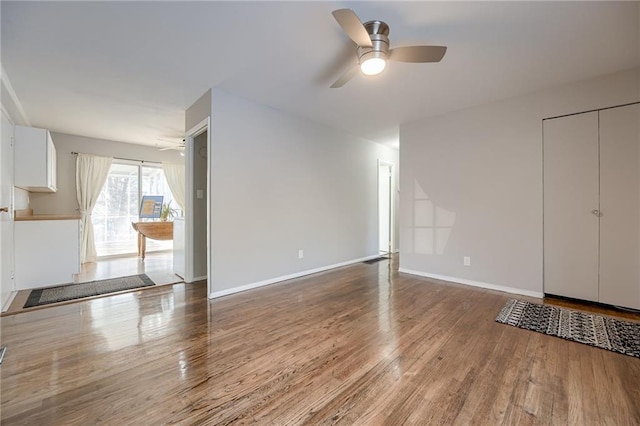 interior space with hardwood / wood-style floors and ceiling fan