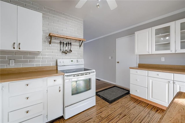 kitchen featuring white electric range oven, white cabinetry, crown molding, light hardwood / wood-style flooring, and decorative backsplash