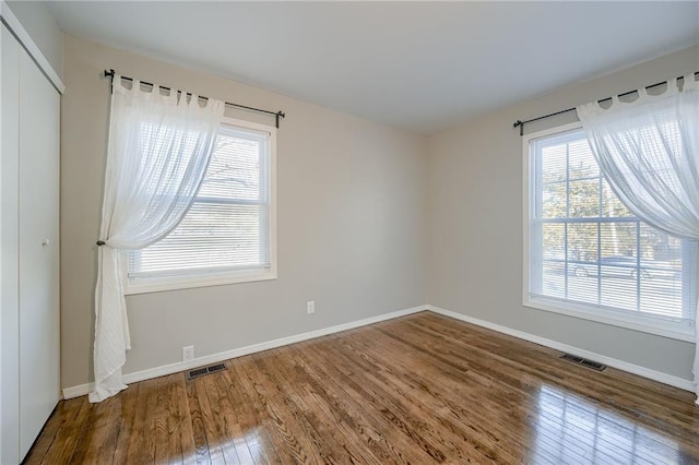 unfurnished room featuring dark hardwood / wood-style floors