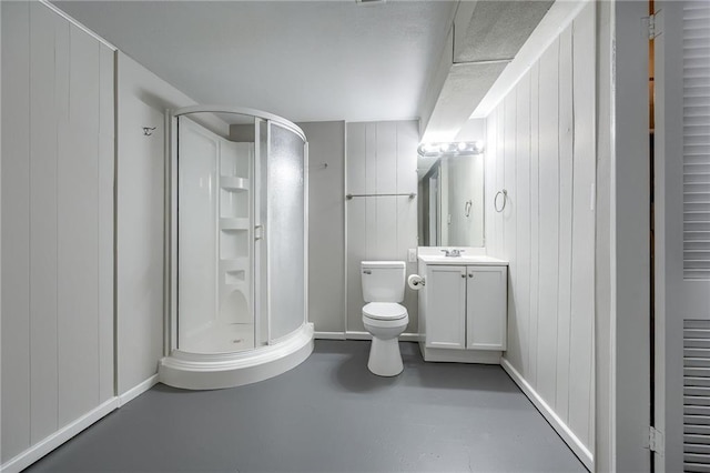 bathroom with wooden walls, a shower with shower door, concrete floors, vanity, and toilet