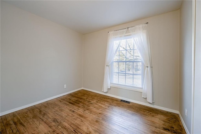 empty room with hardwood / wood-style floors