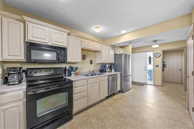 kitchen featuring visible vents, light countertops, a textured ceiling, black appliances, and a sink