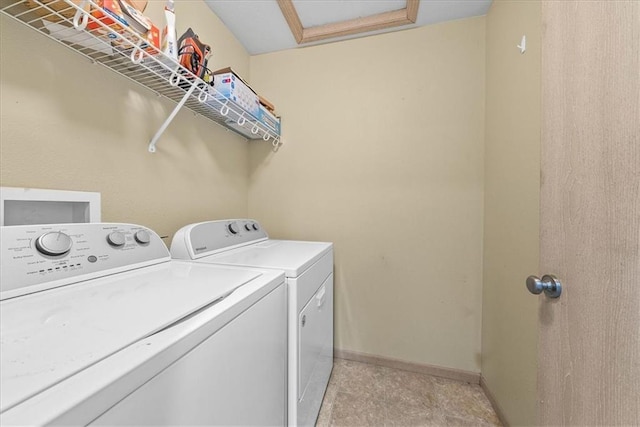 washroom featuring laundry area, attic access, baseboards, and washer and clothes dryer