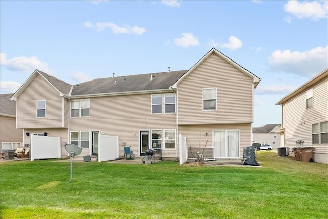 back of property featuring central air condition unit, a patio, and a lawn