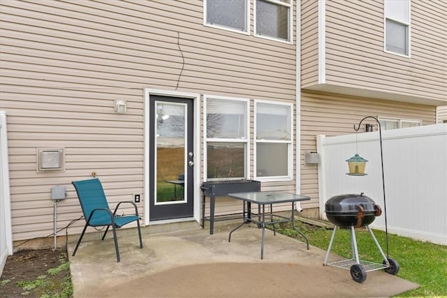 view of patio with a grill and fence