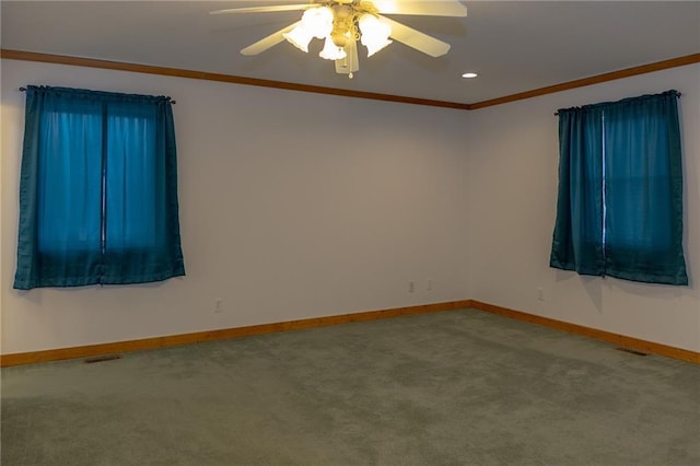 empty room featuring ornamental molding, carpet, and ceiling fan