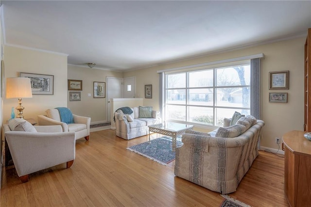 living room with baseboards, light wood-style flooring, and crown molding