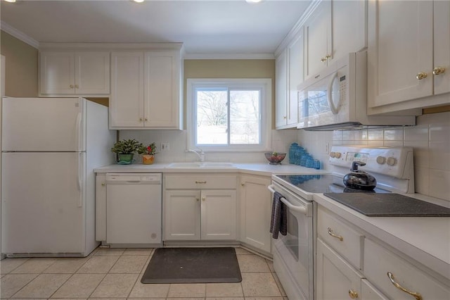 kitchen featuring light countertops, white appliances, and white cabinetry