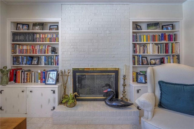 living area with built in shelves and a fireplace