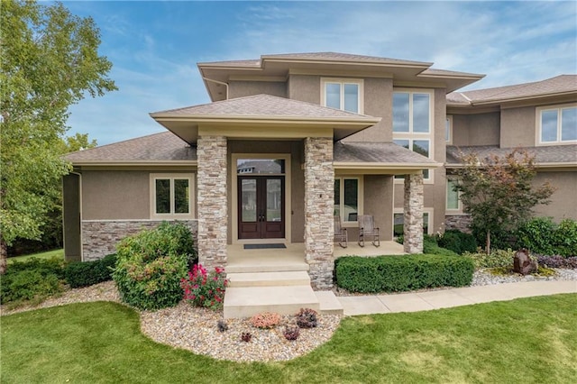 property entrance featuring stucco siding, a shingled roof, stone siding, and french doors