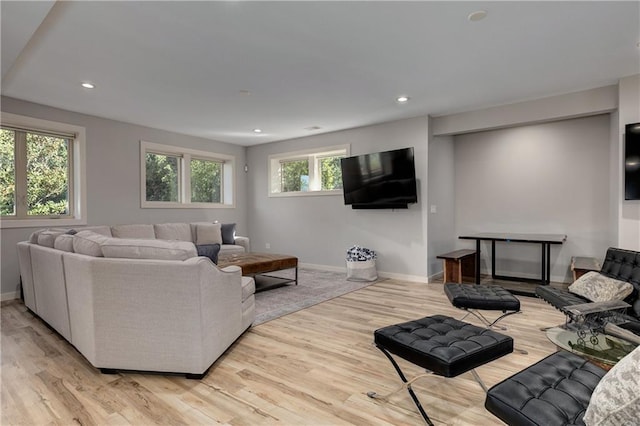 living area with light wood-type flooring, baseboards, and recessed lighting