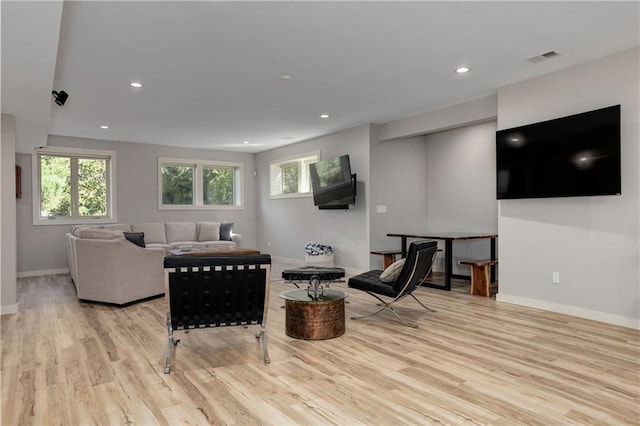 living area featuring recessed lighting, baseboards, and wood finished floors