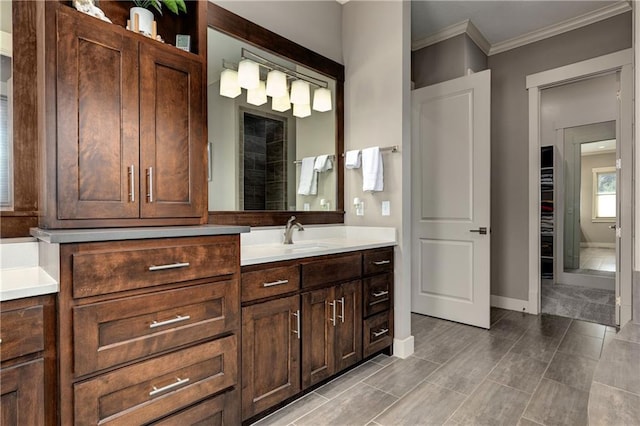 full bath featuring ornamental molding, vanity, and baseboards