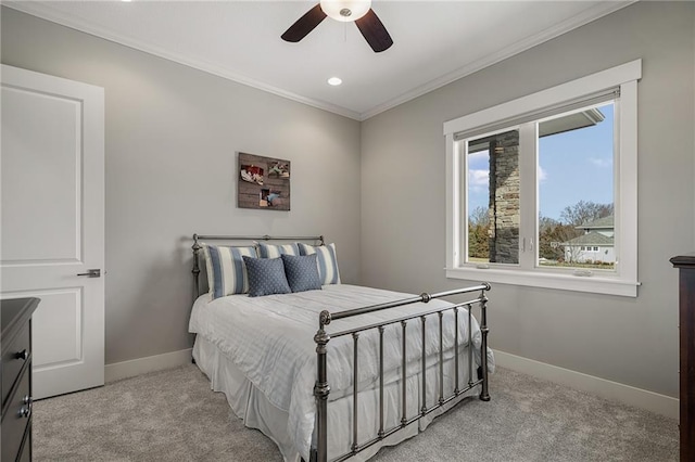 bedroom with a ceiling fan, light carpet, crown molding, and baseboards