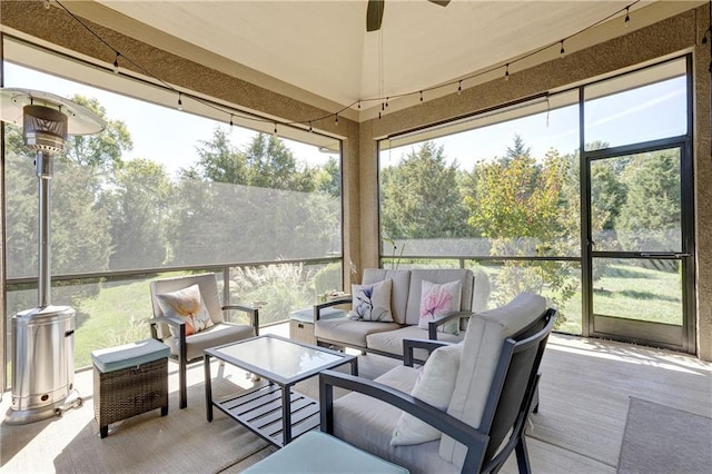 sunroom / solarium featuring a ceiling fan and a healthy amount of sunlight