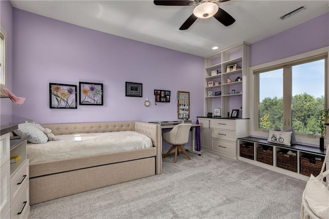 bedroom featuring ceiling fan, visible vents, and light colored carpet