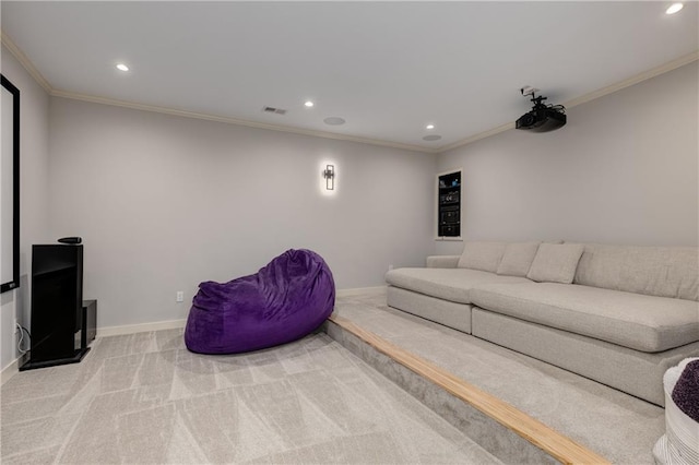 home theater room with recessed lighting, baseboards, ornamental molding, and light colored carpet