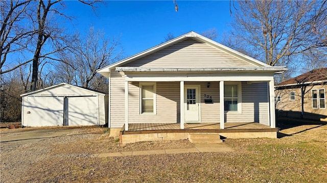 view of front of home featuring an outbuilding, a garage, and covered porch