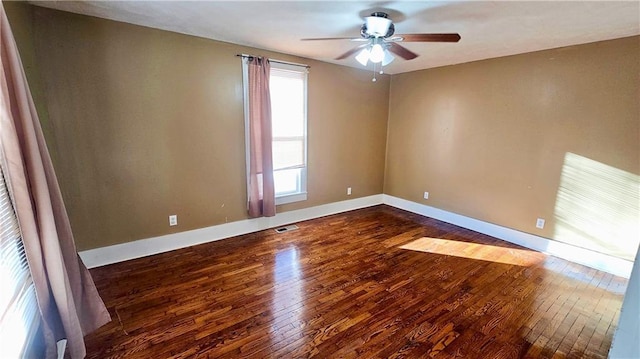 spare room with dark hardwood / wood-style floors and ceiling fan