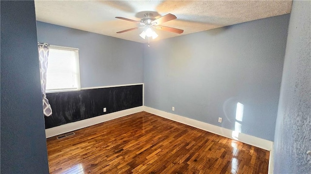 spare room featuring hardwood / wood-style floors, a textured ceiling, and ceiling fan