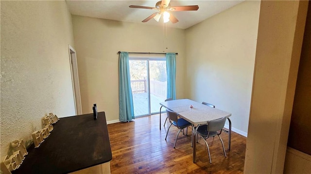 dining room with dark wood-type flooring and ceiling fan