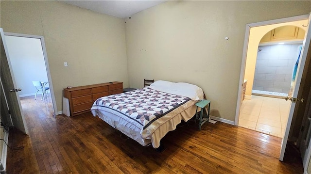 bedroom with dark hardwood / wood-style flooring