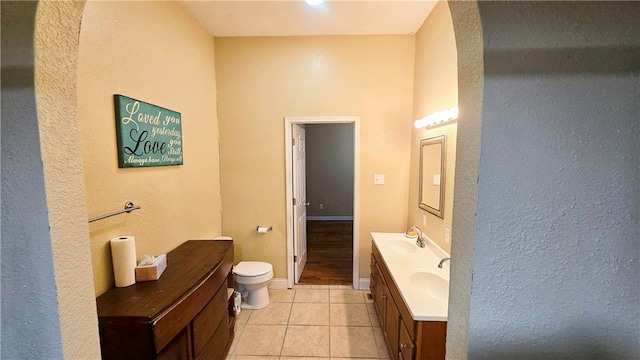 bathroom featuring vanity, toilet, and tile patterned flooring