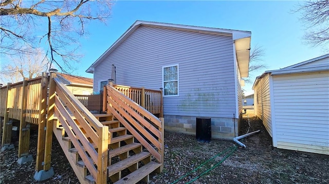 back of house with a wooden deck