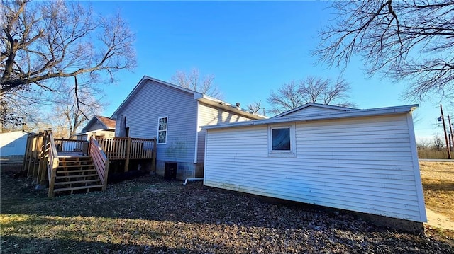 back of house with a wooden deck