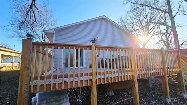 rear view of house with a wooden deck