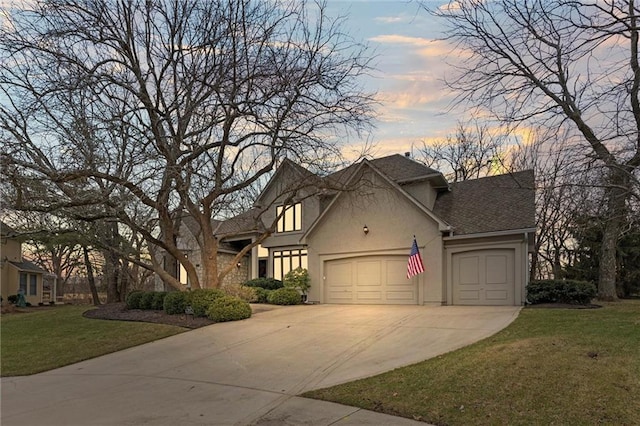 view of front of property featuring an attached garage, a shingled roof, driveway, stucco siding, and a front yard