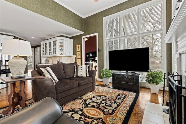 living room with ornamental molding and light wood-style flooring