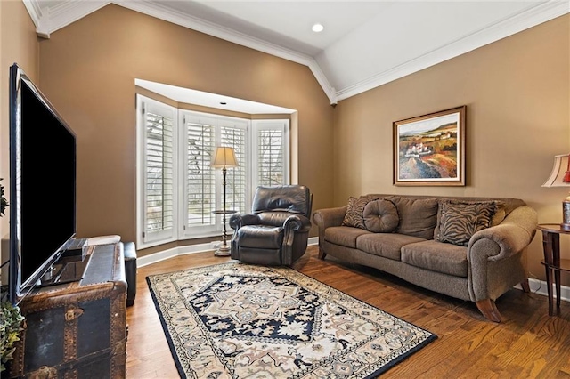 living area featuring crown molding, vaulted ceiling, baseboards, and wood finished floors