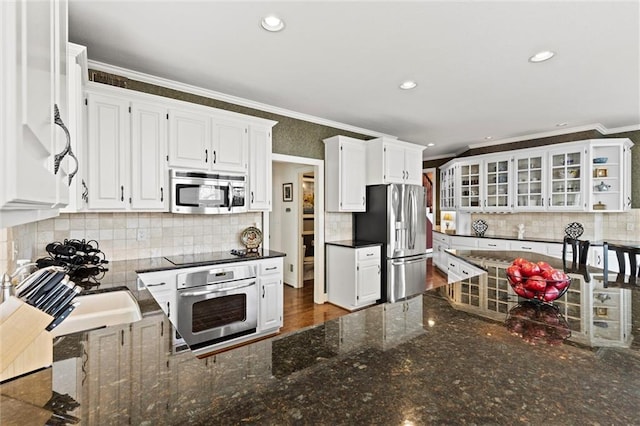 kitchen featuring stainless steel appliances, ornamental molding, recessed lighting, and white cabinets