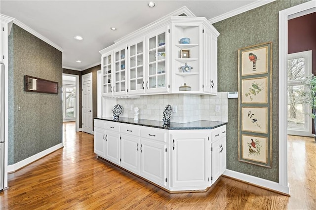 kitchen with crown molding, open shelves, white cabinetry, and wallpapered walls