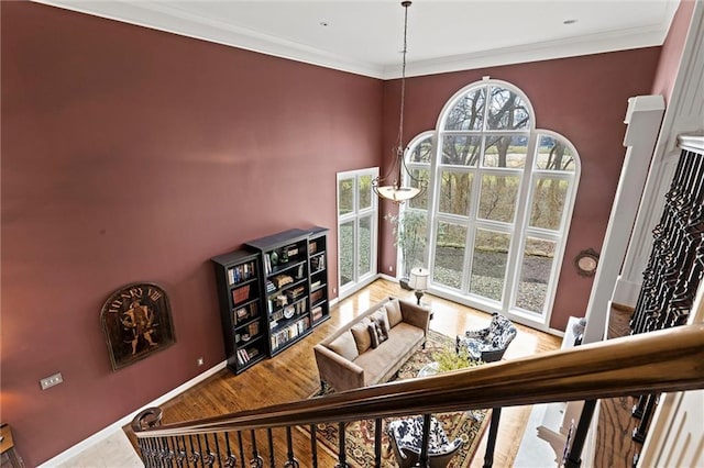 interior space featuring ornamental molding, baseboards, and wood finished floors